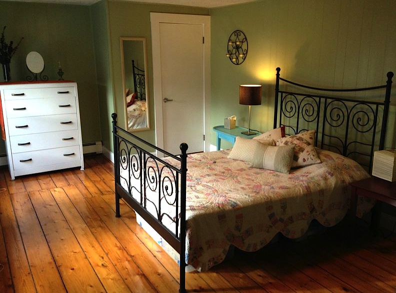 Guest room with second-hand dresser, hand-me-down quilt, and a used table I re-painted